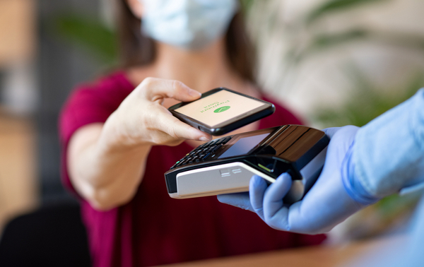 A woman using contactless payment.