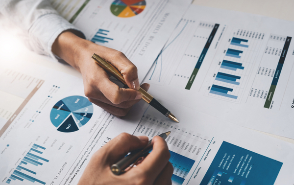 Two people looking over financial reports.