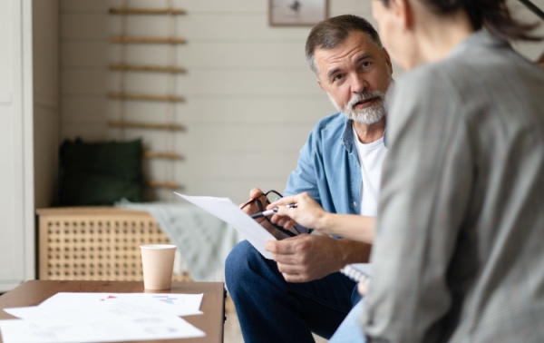 A middle-aged couple going through forms together.