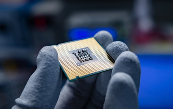 A hand holding a CPU.