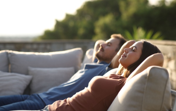 A man and a woman relaxing in the sun